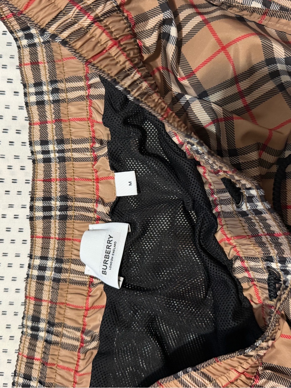 Burberry Tan Plaid Swim Trunks with Black and Red Accents